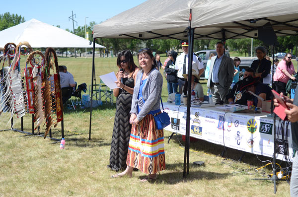 Payton Sinclair-Key, a graduate from Scott Collegiate, and Shannon Fayant, principal of Scott Collegiate, speak at the second annual graduation powwow at First Nations University of Canada.