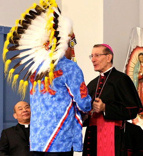 Saskatoon Tribal Council Vice-Chief Marc Arcand (left) welcomes Canada's Vatican Ambassador Luigi Bonazzi (right) to the Treaty 6 Territory as Father Tuyen Vu (far left, below) looks on.<Br>